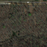 An aerial view of 5.5 acres with creek.